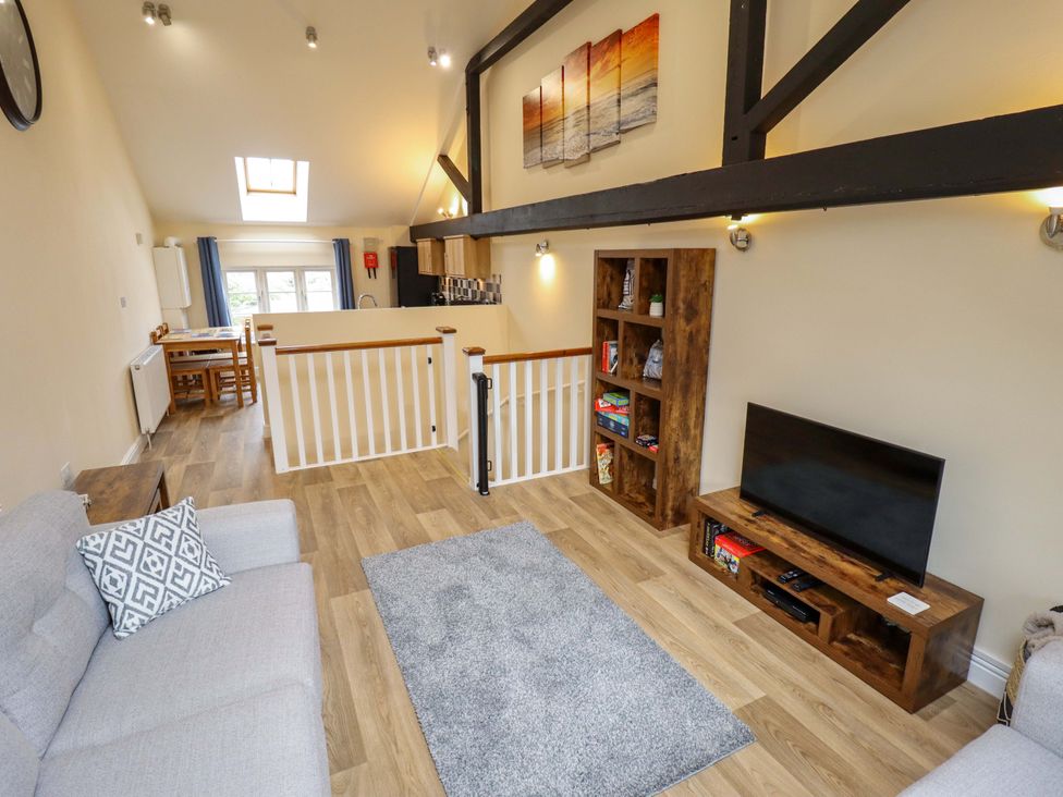 A living room with a sofa and television at 3 The Old Drill Hall Alford