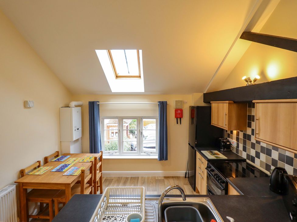 A kitchen with a table and chairs at 3 The Old Drill Hall Alford