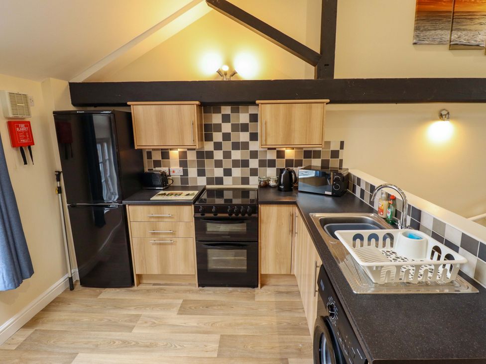 A kitchen with appliances and cabinets at 3 The Old Drill Hall Alford
