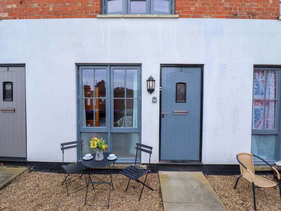 An outdoor seating area with a table and chairs at 3 The Old Drill Hall Alford