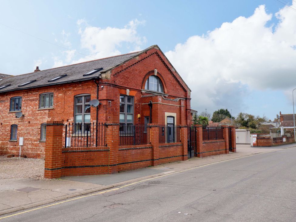 A brick building with a front fence and windows at 3 The Old Drill Hall Alford