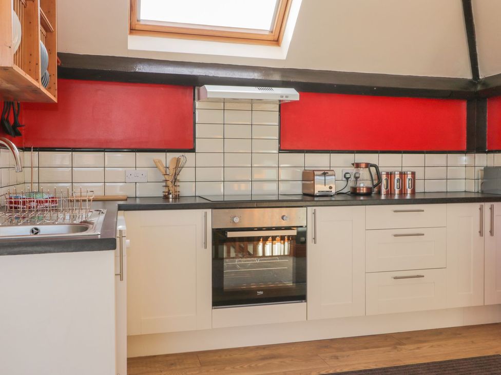 A kitchen with a sink, oven, and countertop appliances at Atelier in Bridlington