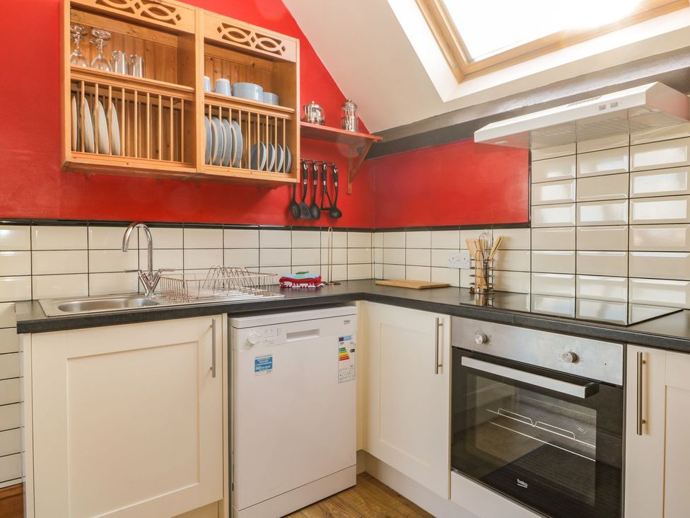 A kitchen with a sink, oven, and dishwasher at Atelier in Bridlington