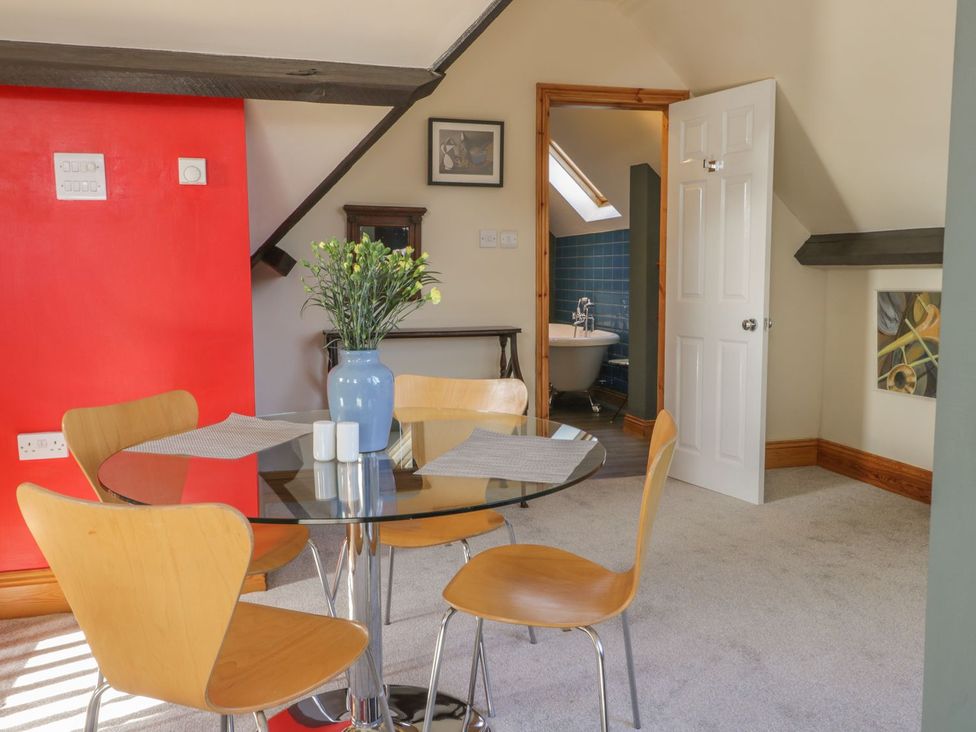 A dining room with a table and chairs at Atelier in Bridlington