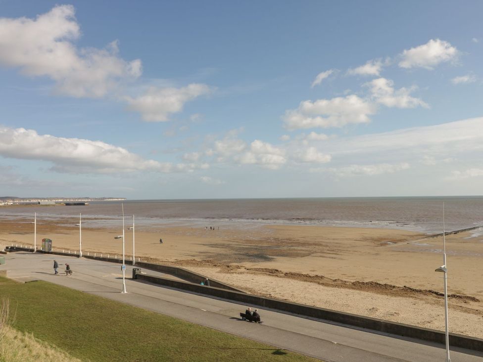 A beach with people walking near the sea at Atelier in Bridlington