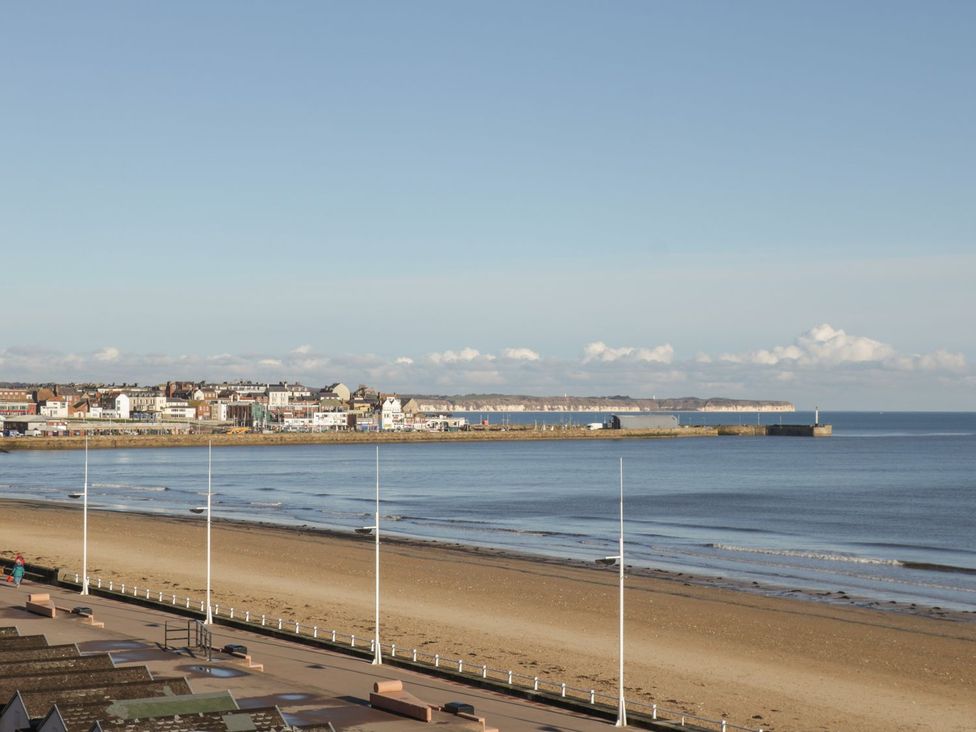 A view of the beach and sea with buildings in the background at Atelier in Bridlington