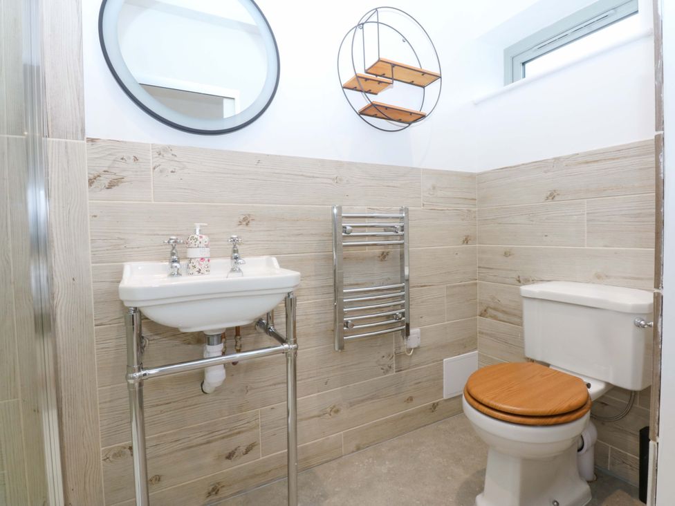 A bathroom with a sink and toilet at Gowan Brae in Criccieth