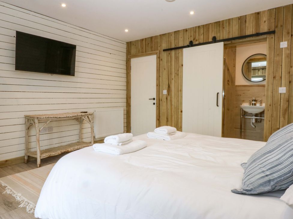 A bedroom with a bed and a television at Gowan Brae in Criccieth