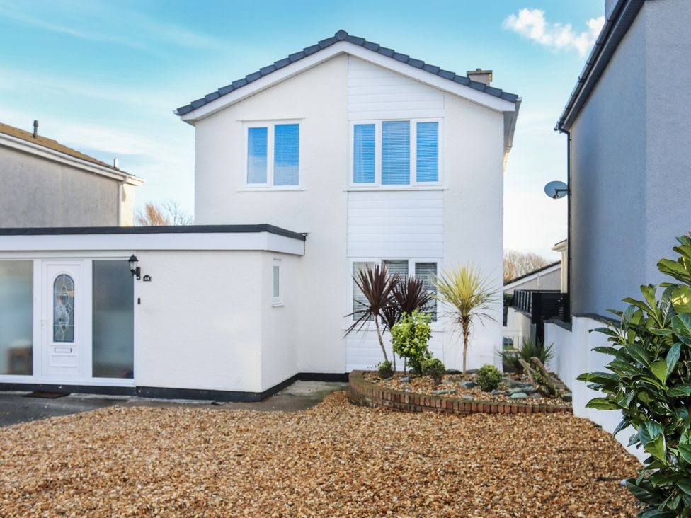 A house with gravel driveway and plants at Penrhos Walks Holyhead