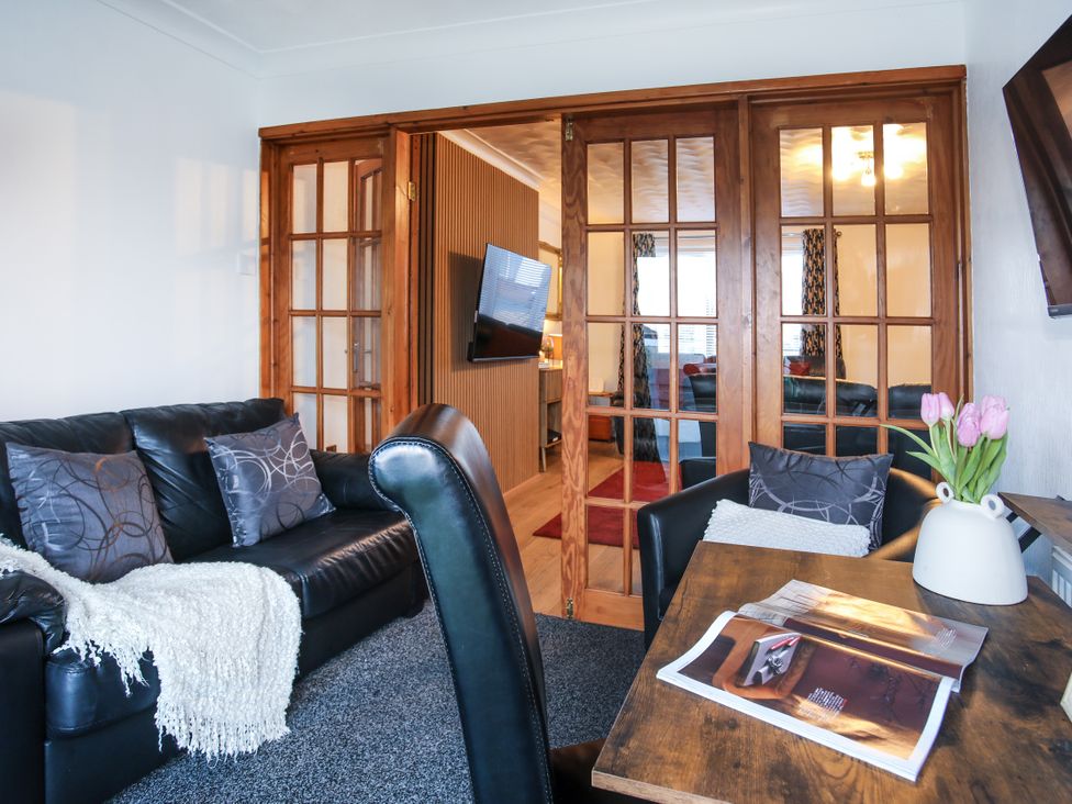 A living room with a sofa and a table at Penrhos Walks in Holyhead