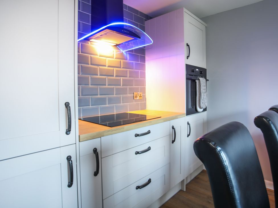 A kitchen with cabinets and an oven at Penrhos Walks in Holyhead