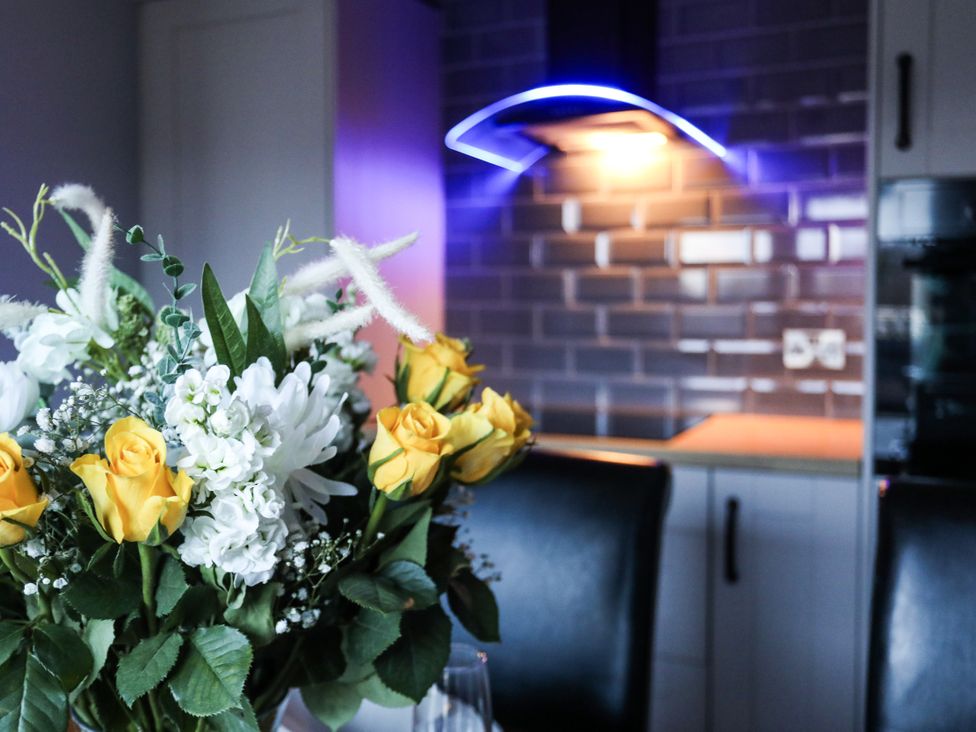 A flower arrangement on a table in a kitchen at Penrhos Walks in Holyhead