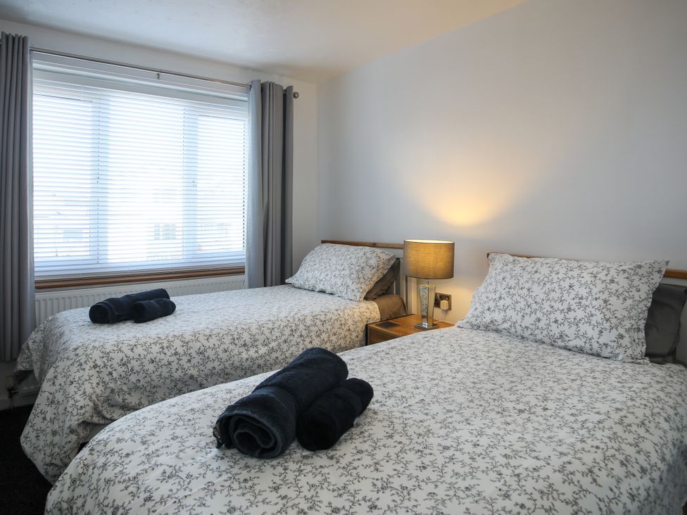 A bedroom with two beds and a lamp at Penrhos Walks in Holyhead