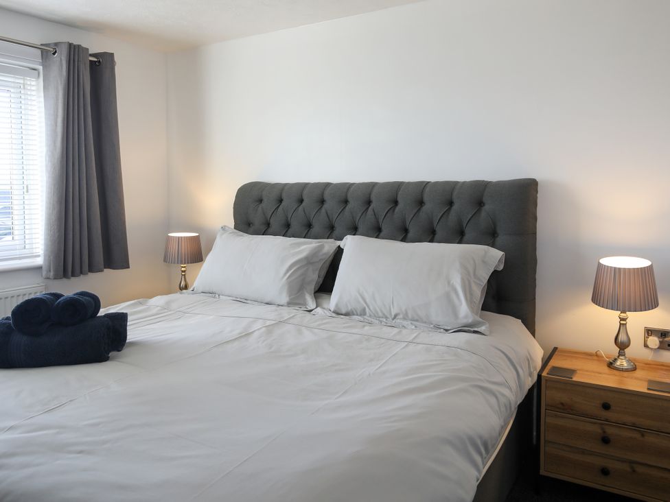 A bedroom with a bed and lamp at Penrhos Walks Holyhead