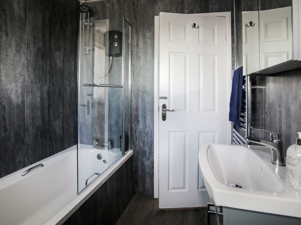 A bathroom with a bathtub and shower at Penrhos Walks in Holyhead