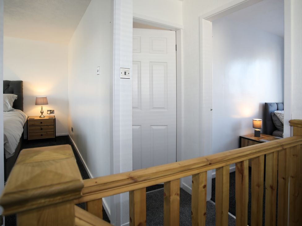 A hallway with doors and lamps at Penrhos Walks in Holyhead