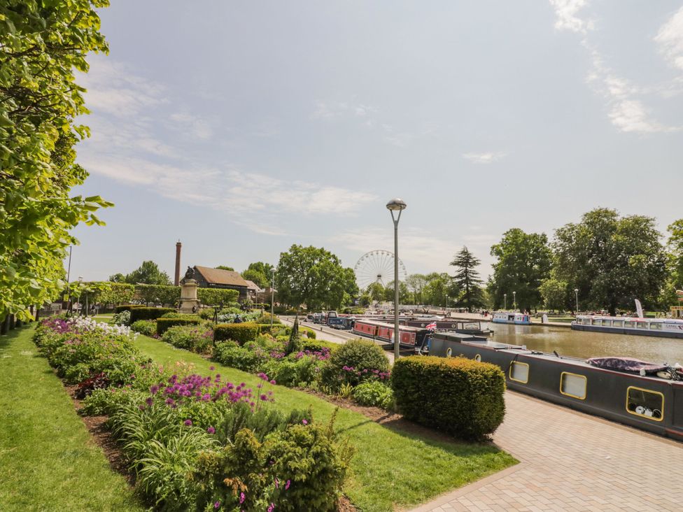 A canal with boats and flower beds at The Shed in Stratford-upon-Avon
