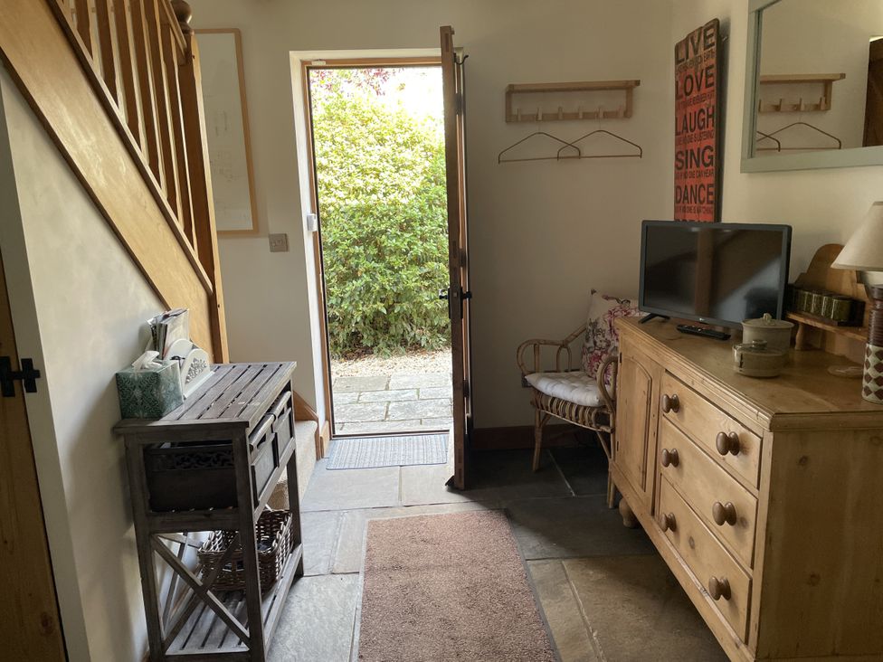 A hallway with a door leading outside at The Shed in Alveston near Tiddington