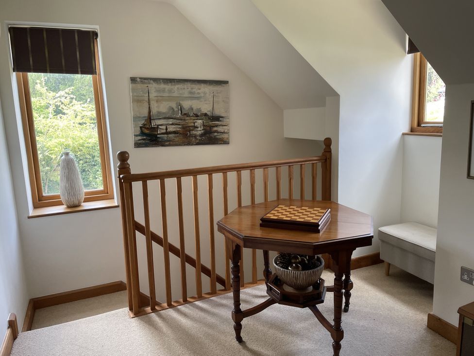 A landing area with a table and a chair at The Shed Alveston near Tiddington