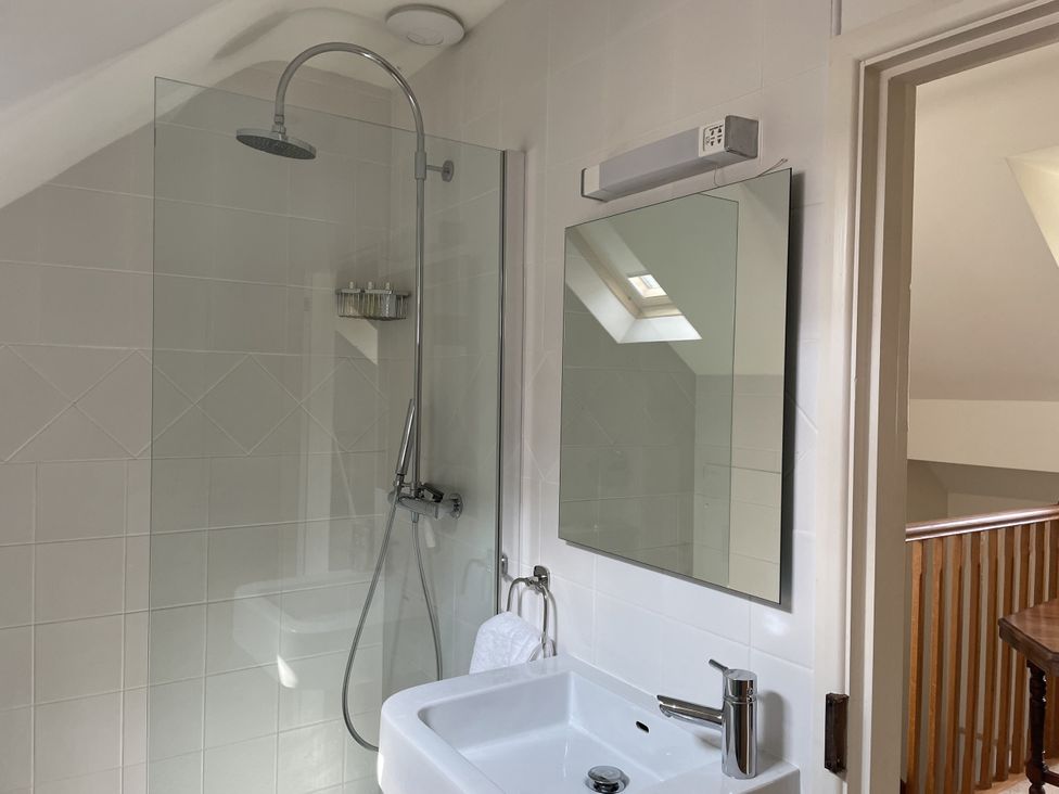 A bathroom with a shower, sink and mirror at The Shed in Alveston near Tiddington