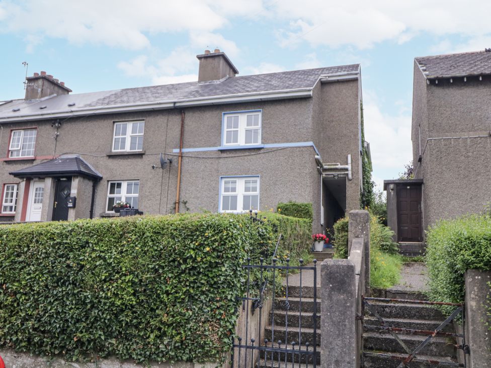 A house with a hedge and steps at Burna Letterkenny
