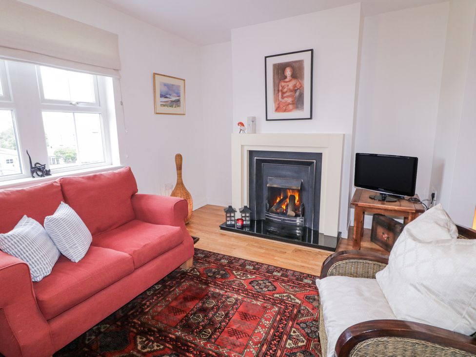 A living room with a sofa and fireplace at Burna in Letterkenny