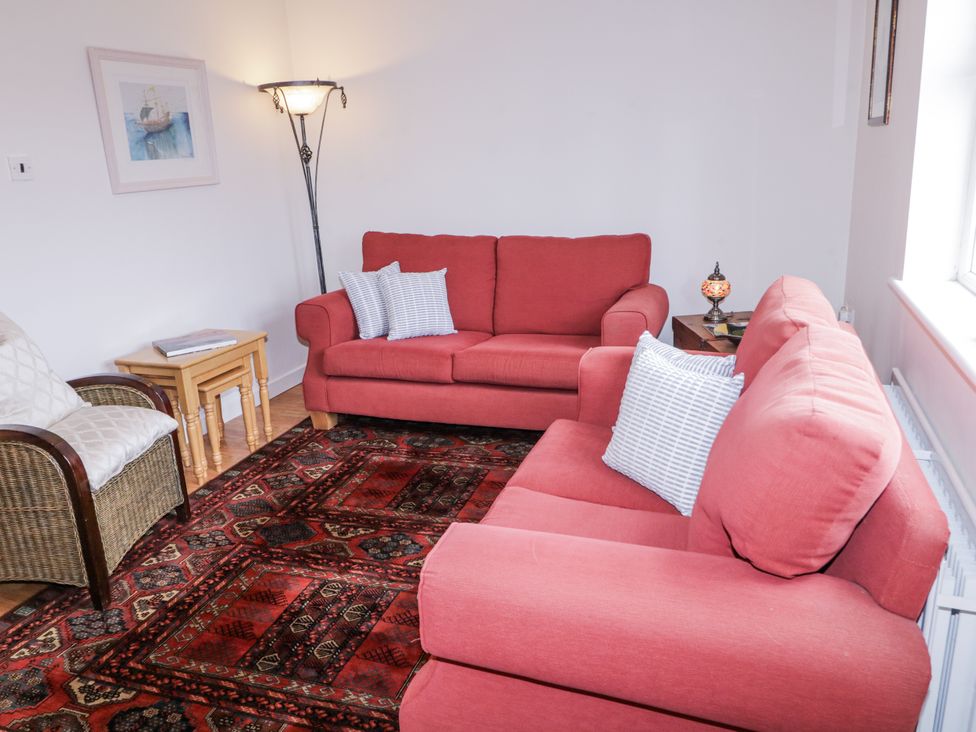 A living room with sofas and a lamp at Burna in Letterkenny