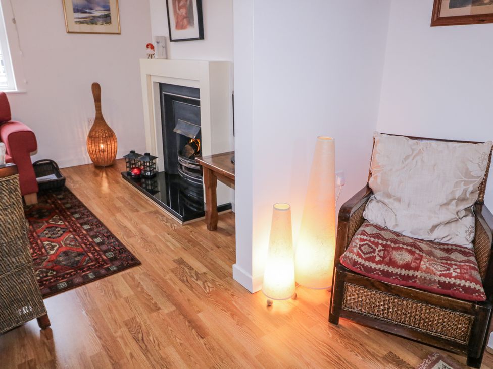 A living room with a fireplace and seating at Burna in Letterkenny