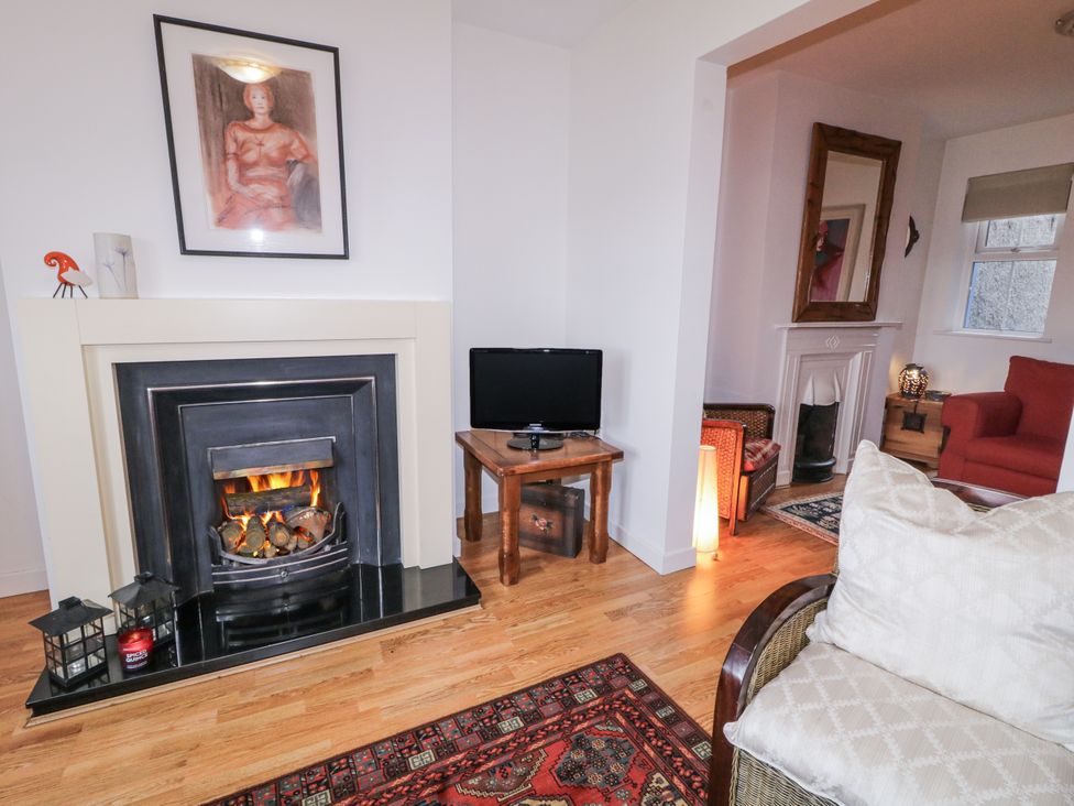 A living room with a fireplace and a television at Burna in Letterkenny