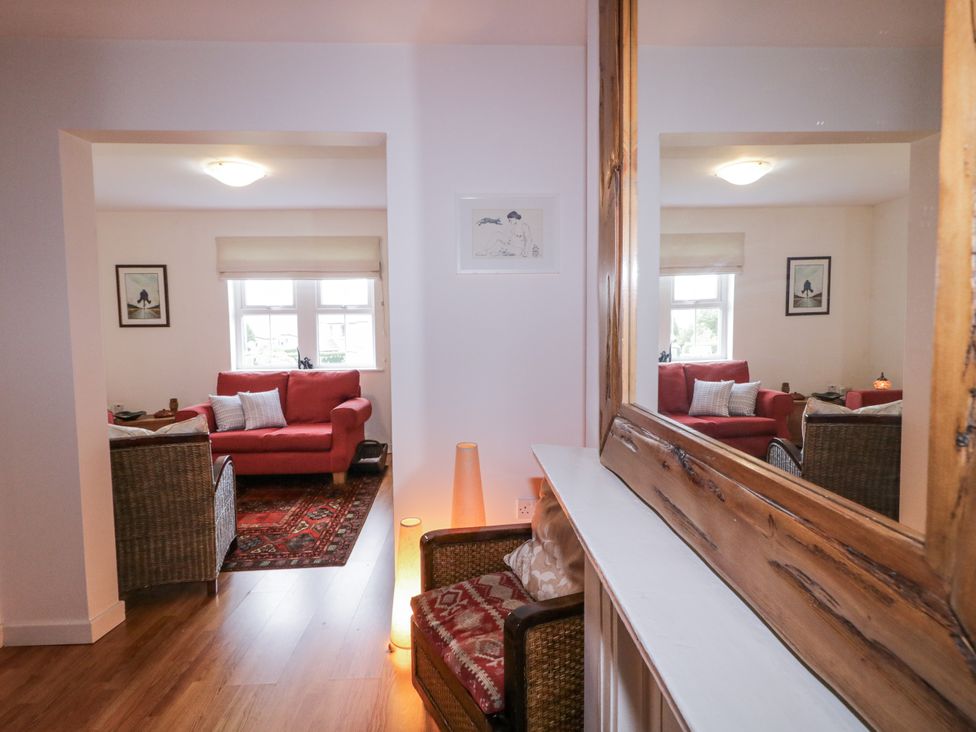 A living room with a sofa, armchair and artwork at Burna in Letterkenny