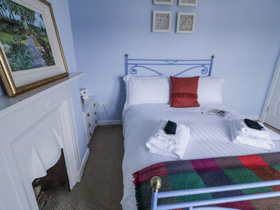 A bedroom with a bed and towels arranged at Burna in Letterkenny