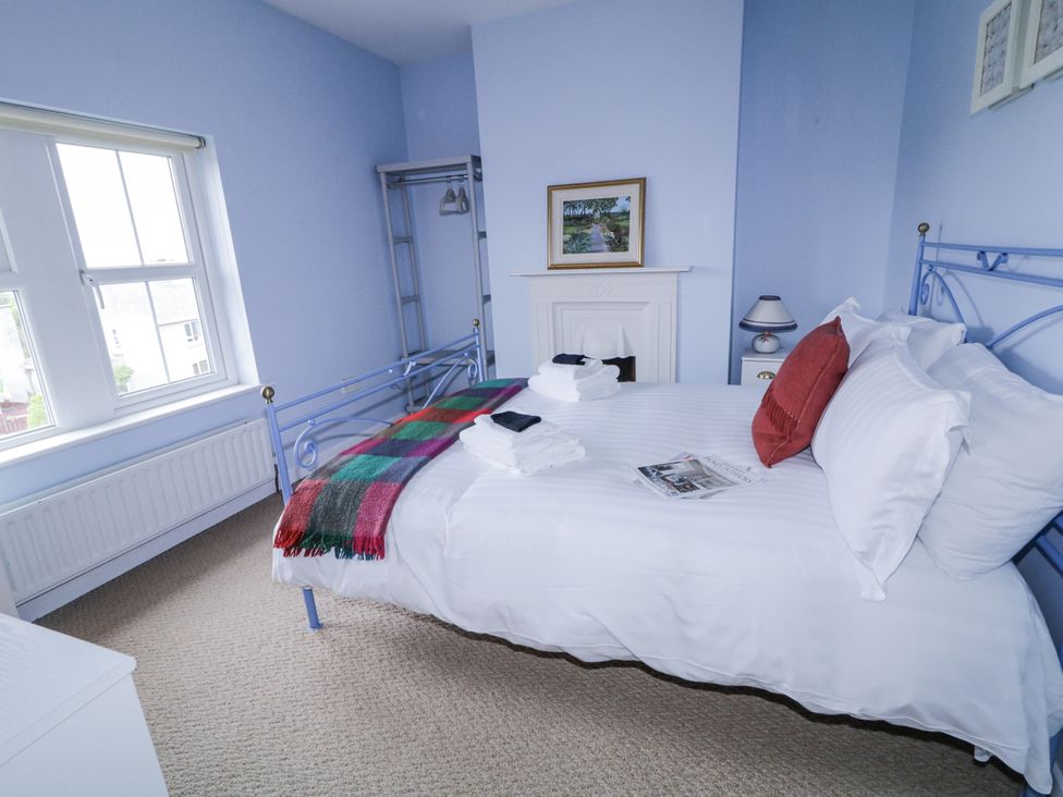 A bedroom with a bed and wardrobe at Burna in Letterkenny