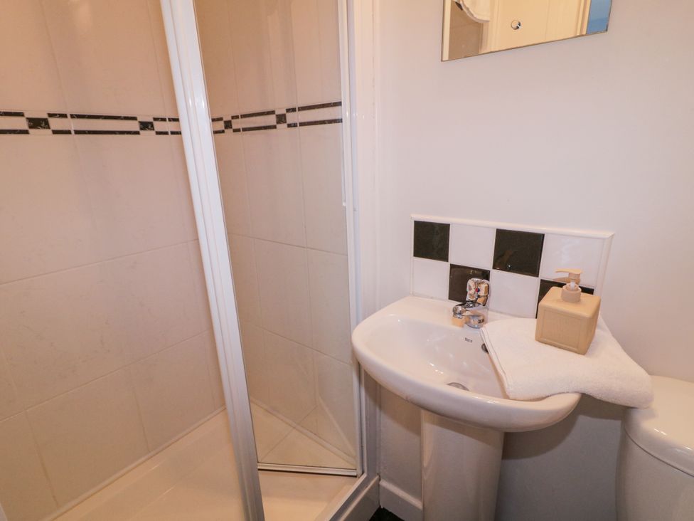 A bathroom with a shower and wash basin at Burna in Letterkenny