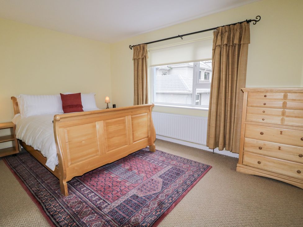 A bedroom with a bed and dresser at Burna in Letterkenny