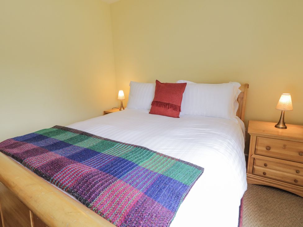 A bedroom with a bed and nightstand at Burna in Letterkenny