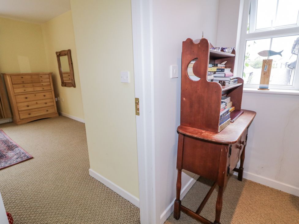 A bedroom with a dresser and wooden table at Burna in Letterkenny