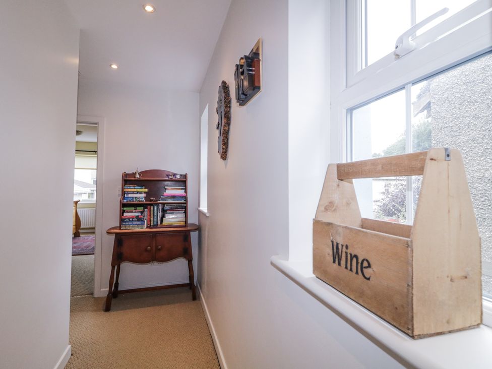 A hallway with a bookshelf and a wine box at Burna in Letterkenny