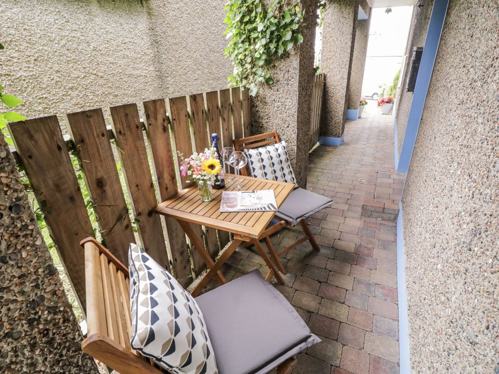 An outdoor patio with a table and chairs at Burna in Letterkenny