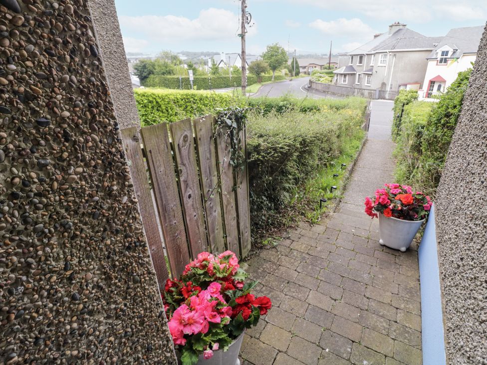 A pathway with flowers leading to the street at Burna in Letterkenny