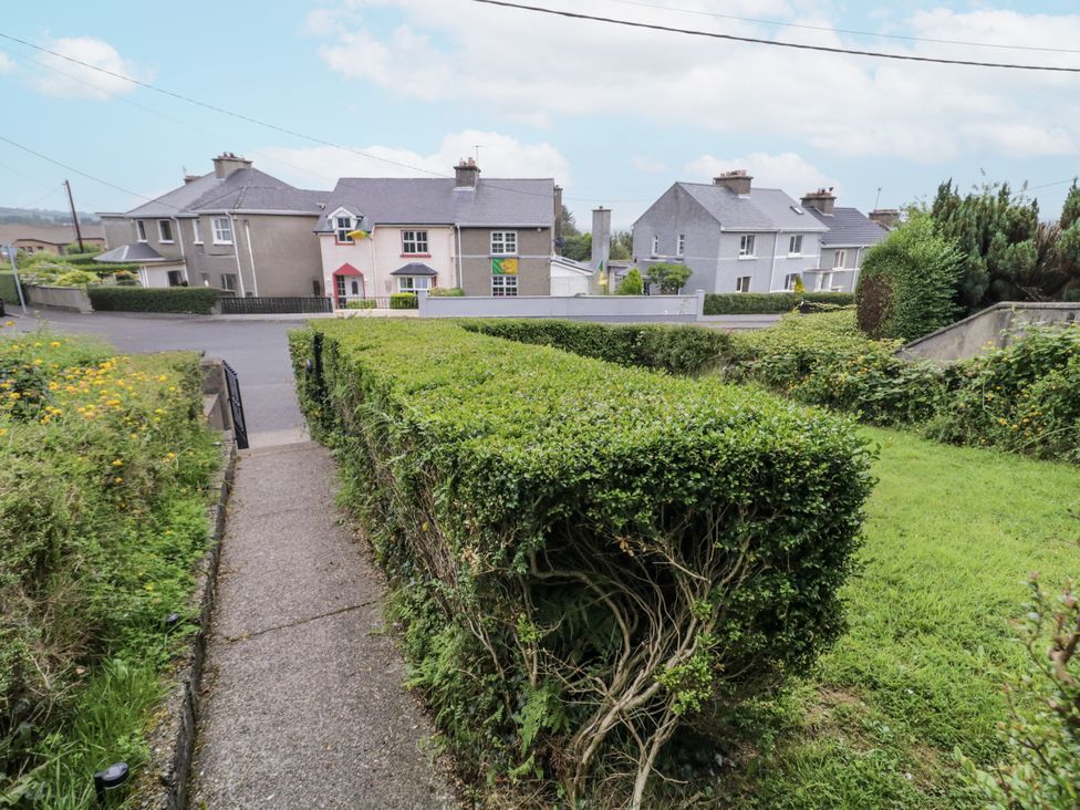 An outdoor view with houses and a hedge at Burna in Letterkenny