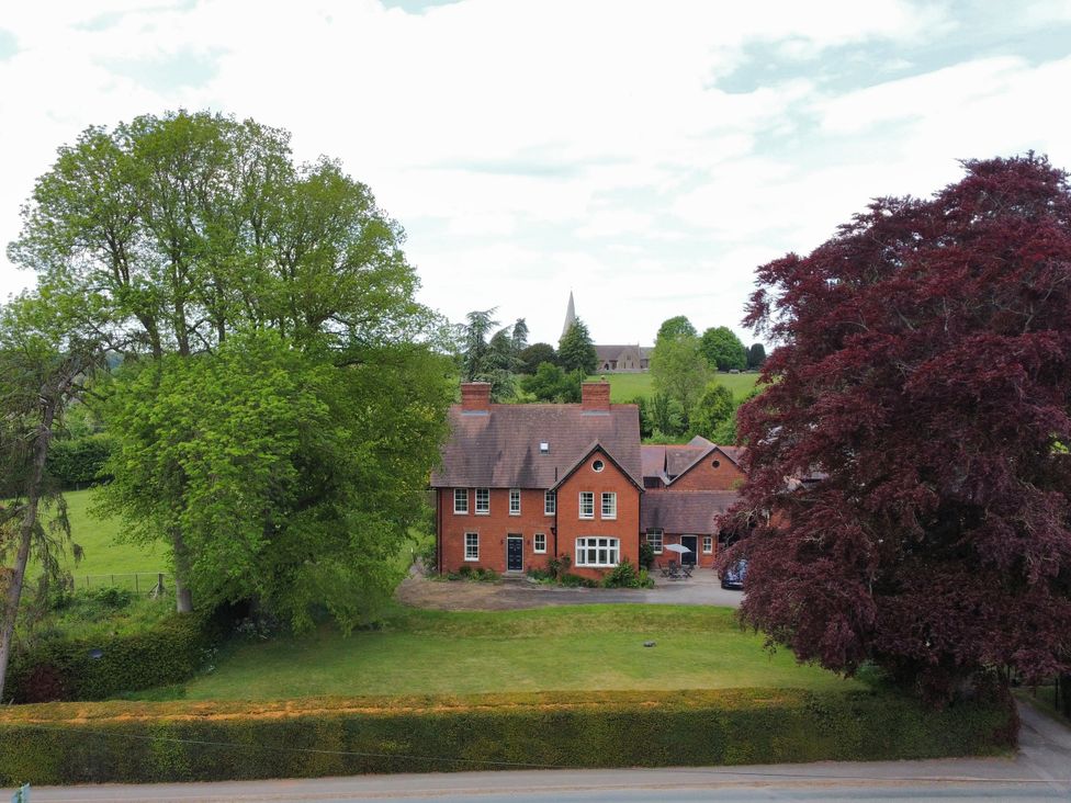 A house with a garden and trees at The Old Vicarage in 
