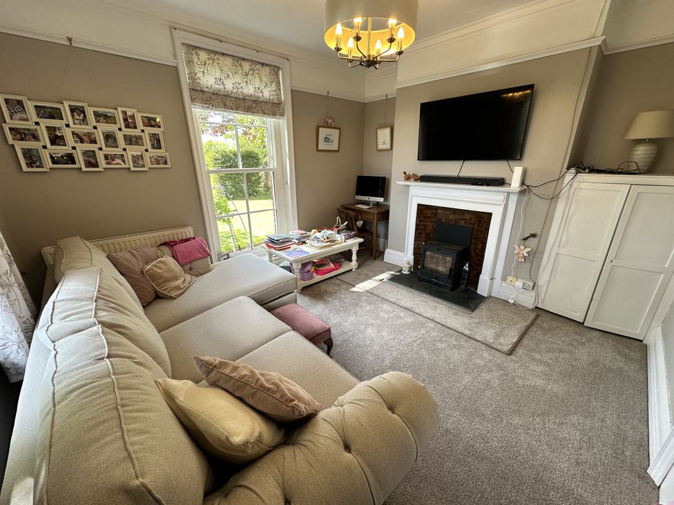 A living room with a sofa and a coffee table at The Old Vicarage