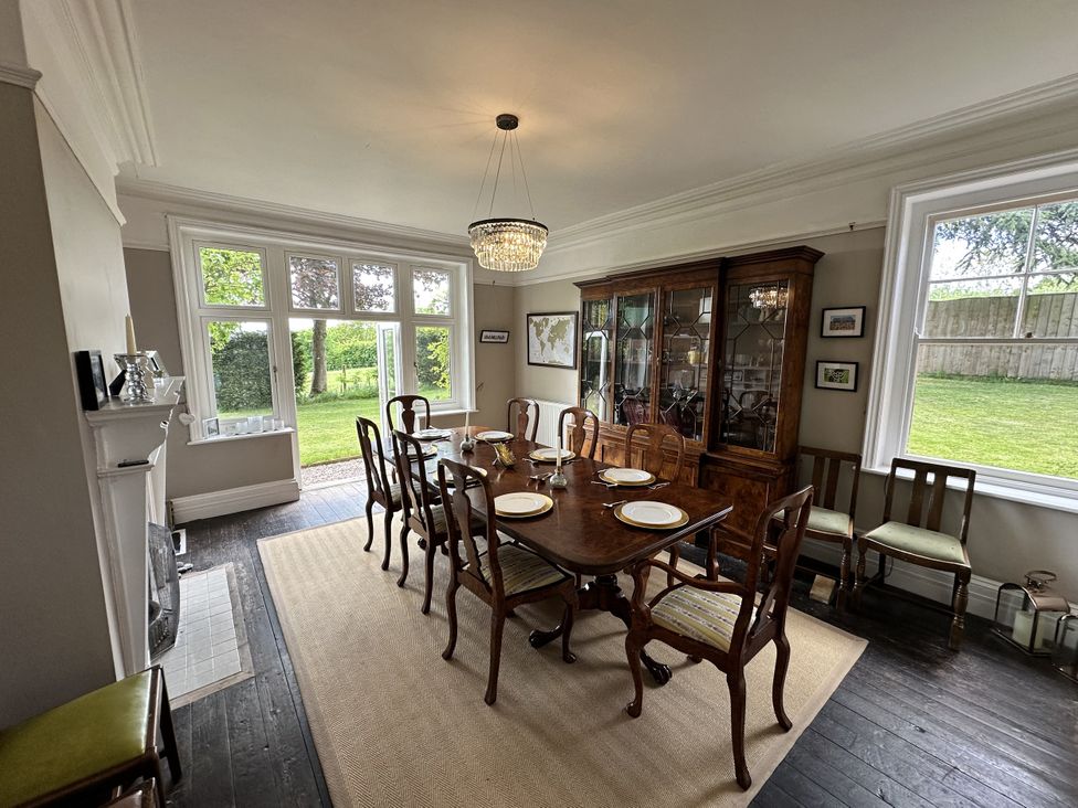 A dining room with a table set for meals at The Old Vicarage in 