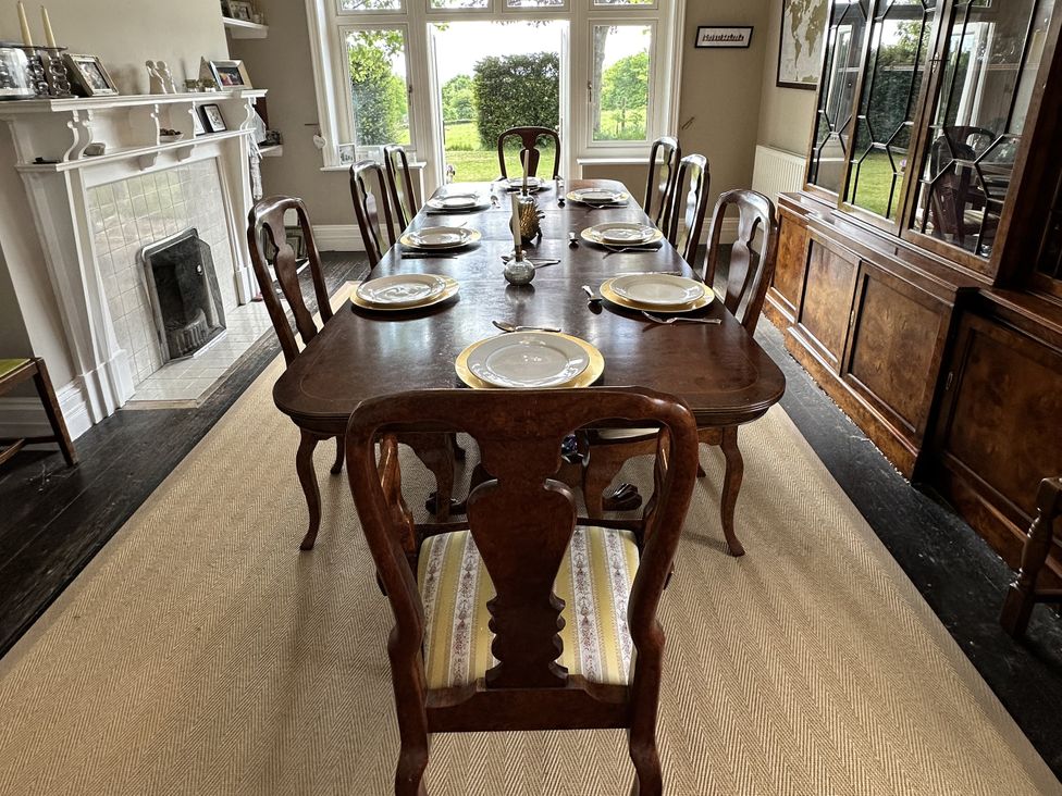 A dining room with a wooden table and chairs at The Old Vicarage 