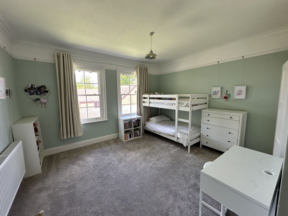 A bedroom with a bunk bed and dresser at The Old Vicarage 