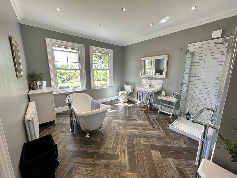 A bathroom with a bathtub and sink at The Old Vicarage