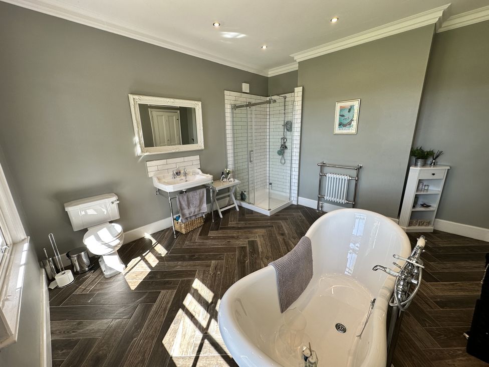 A bathroom with a bathtub and shower at The Old Vicarage 