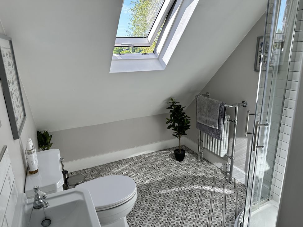 A bathroom with a shower, sink, and toilet at The Old Vicarage 
