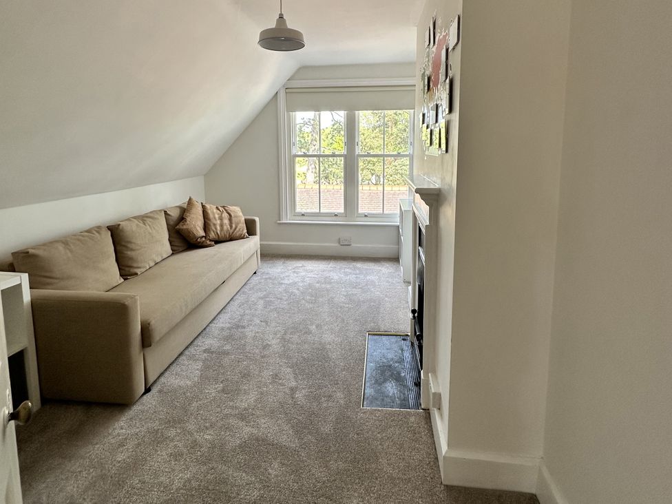 A living room with a sofa and window at The Old Vicarage in 