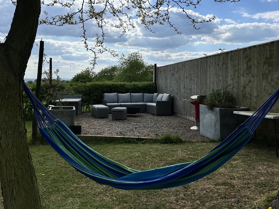 A garden with a hammock and outdoor seating area at The Old Vicarage 
